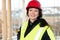 Confident Female Carpenter In Protective Wear At Site