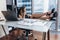 Confident female chief executive talking on phone while sitting with her feet on desk at work