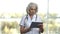 Confident female doctor using digital tablet.