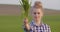 Confident Female Farmer Showing Young Crops At Farm