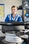 Confident Female Mechanic Mounting Car Tire On Rim In Garage