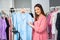 Confident female online retail seller presenting new arrivals of clothes to customers on social media, Online selling business