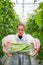 Confident female researcher showing container full of green bean