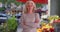 Confident female small business owner standing in front of flower shop