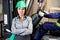Confident Female Supervisor With Forklift Driver