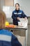 Confident female in workwear opening box with medical stuff during basics of life safety lesson