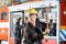 Confident Fireman Holding Axe At Fire Station