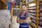 Confident friendly man working in warehouse in hypermarket of building materials.