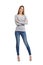 Confident full body of a casual happy woman standing wearing jeans