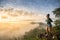 Confident girl standing on top of the mountain