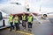 Confident Ground Crew Walking Against Airplane