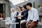 confident group of young Asian entrepreneurs sit with a group of colleagues