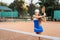 Confident handling of the ball when playing on the net. An attractive, beautiful tennis player practicing exercises to improve her