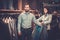 Confident handsome man with beard choosing a jacket in a suit shop.