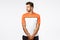 Confident handsome young football player in sports t-shirt standing in wall pose during soccer match, turn sideways