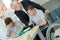 Confident happy student in wheelchair working at office desk