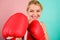 Confident in her boxing skill. Boxing improve temper and will. Concentrated on punch. Woman boxing gloves focused on