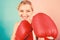 Confident in her boxing skill. Boxing improve temper and will. Concentrated on punch. Woman boxing gloves focused on