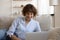 Confident lady recline on couch engaged in chatting by laptop