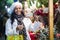 Confident Latin American woman chooses a composition of flowers