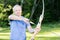 Confident Male Archer Holding Bow And Arrow In Forest