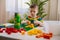 Confident male baby constructing tower with multicolored plastic pieces assembling house on table