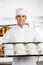 Confident Male Baker Holding Baking Tray