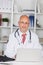 Confident Male Doctor With Laptop At Desk