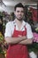 Confident Male Florist Standing In Flower Shop