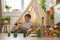 Confident male kid building fortress tower architecture wooden bricks ecology Montessori material