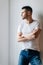 Confident man with crossed arms posing on white background