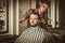 Confident man visiting hairstylist in barber shop.