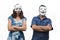 Confident man wearing a happy face mask standing beside a unconfident woman who wearing a sad face mask