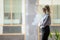 Confident mature businesswoman pondering strategy, standing near window