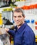 Confident Mature Worker Smiling In Hardware Shop