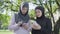 Confident modern Muslim women using smartphones outdoors. Portrait of two young beautiful ladies in hijabs surfing