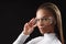 Confident mulatto girl posing with glasses