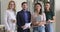 Confident multiracial business people stand in office, team portrait