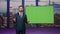 Confident newscast presenter talking daily news in tv studio with green screen.