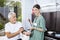 Confident Nurse Examining Blood Pressure Of Senior Man