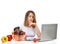 Confident nutritionist woman working at desk with fresh fruits a