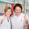 Confident Pharmacists Showing Thumbsup Sign