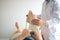 Confident physical therapist helps patient use resistance band stretching out his leg in clinic room