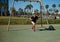 Confident portrait of a handsome Caucasian young man exercising with suspension straps outdoors. Bodyweight training