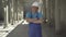 Confident positive man in uniform and helmet crossing hands and smiling at camera. Portrait of Caucasian builder posing