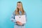 Confident, powerful, smiling blonde teenage girl in glasses holding paper folder, portfolio. Back to school, university