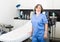 Confident professional elderly woman cosmetologist standing in office