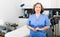 Confident professional elderly woman cosmetologist standing in office