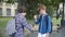 Confident redhead schoolboy meeting classmate outdoors. Portrait of two positive Caucasian friends greeting each other