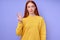 confident redhead woman in yellow stylish sweater demonstrating letter W